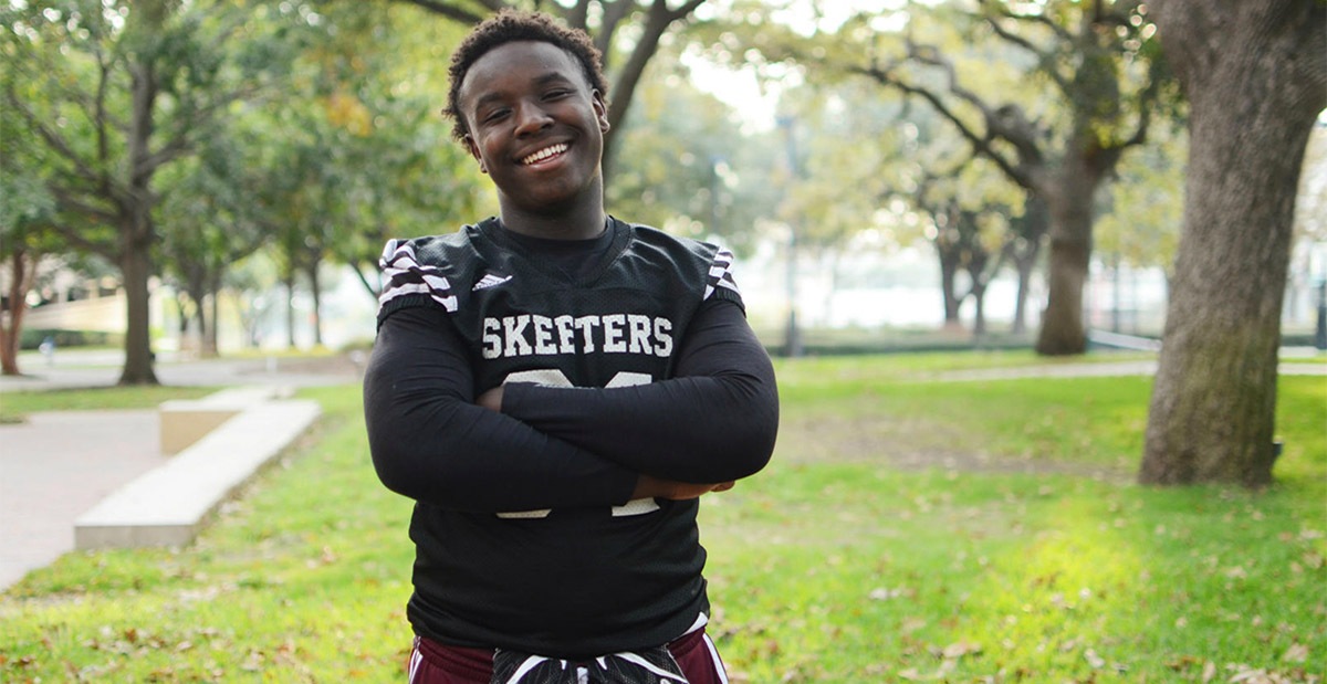 high school boy with black football jersey on