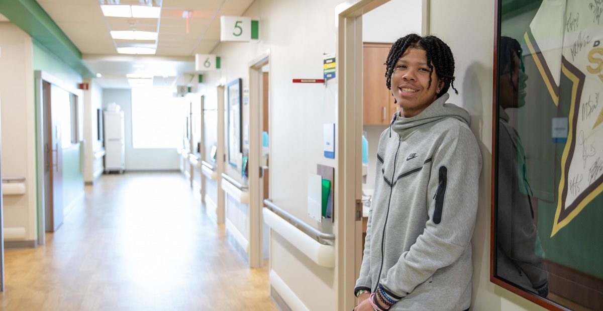 Knee-blog A young man standing in a hallway