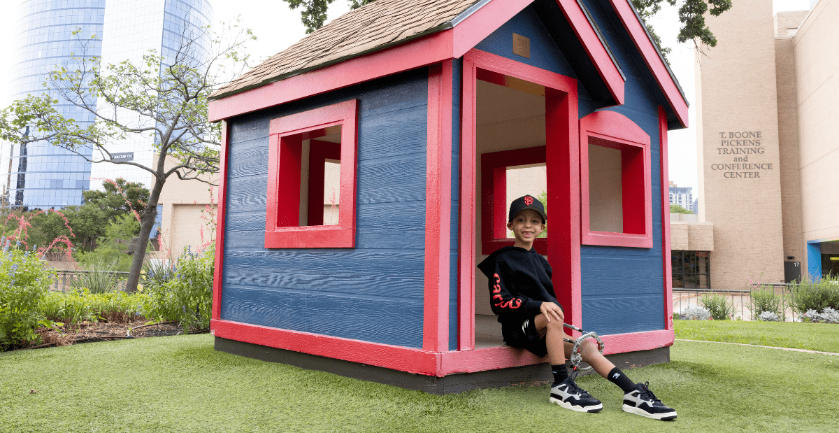 De'Vaun sitting on the playground at Scottish Rite for Children.