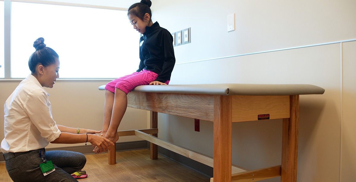 Dr. Jane Chung examining a patient in clinic.