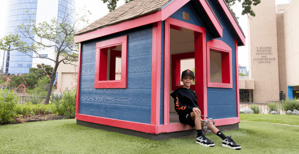 De'Vaun sitting on the playground at Scottish Rite for Children.